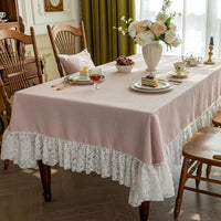 Nappe de table rose et rectangulaire avec dentelle sur une table