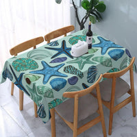 Nappe en Toile Cirée Rectangulaire Motif Coquillage et étoile de mer, dans les tons bleu, dans une salle à manger.